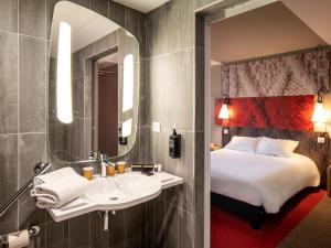 a hotel room with a bed and a sink at ibis Moulins in Moulins