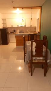 a kitchen with a table and a table and a chair at condominio Crismairy in Bayahibe