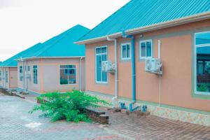 a row of houses with blue roofs at MIAMi VILLA HOTEL in Mpanda