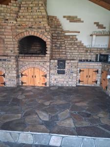 a large room with wooden doors and a stone floor at Pensiunea Edia in Borşa