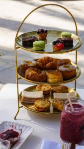 a three tiered display of pastries and donuts on a table at Hotel Alicante Golf in Alicante