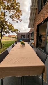 a long table with chairs and a large table at Le Bosquet-Villa Prestige, Parking privé, Jardin, Wifi in Lys-lès-Lannoy