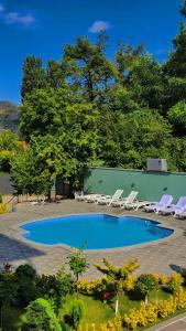 a large swimming pool with lounge chairs around it at BMG Hotel by Grigoryans Group in Goris