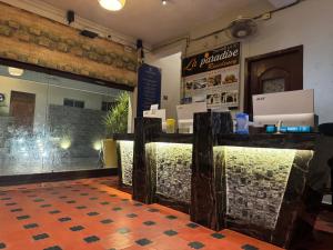 a restaurant with a counter with a window and a table at La Paradise Residency - TIE Hotels in Pondicherry +32 photos