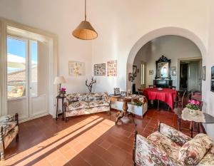 a living room with couches and a table at Dimora Storica Villa Pietralunga in Nicosia