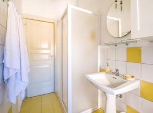 a white bathroom with a sink and a mirror at Dimora Storica Villa Pietralunga in Nicosia