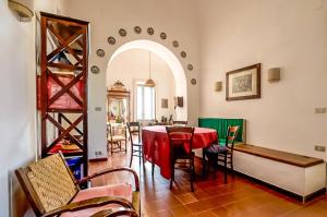 a dining room with a red table and chairs at Dimora Storica Villa Pietralunga in Nicosia +17 photos