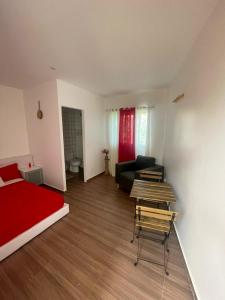 a living room with a red bed and a couch at Rubera - Refúgios & Sabores in Nora
