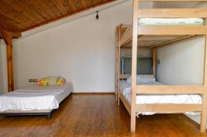 two bunk beds in a room with wooden floors at Buff Hostel Tirana in Tirana