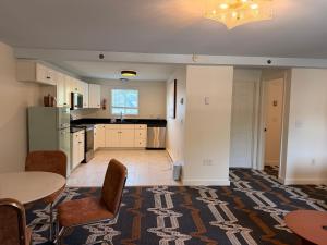 a kitchen with a table and chairs in a room at Driftaway Hotel and Pool in Ogunquit