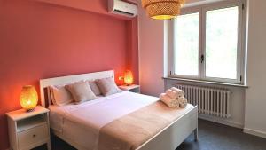 a bedroom with a large white bed with two lamps at Villa Mario in Senigallia