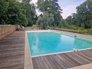 a swimming pool with blue water in a yard at Château de La Sizeranne - Beausemblant in Beausemblant