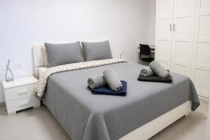 a bedroom with a bed with two pillows on it at Seguro Spacious apartment with roomy terrace, newly renovated in Puerto de Santiago