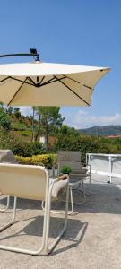 a white umbrella sitting on top of a patio at Private Pool River View Villa in Baião