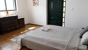 a bedroom with a bed with two stuffed animals on it at Private Pool River View Villa in Baião +32 photos