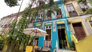 a blue building with an umbrella in front of it at Sobrado Antonieta in Belém