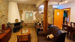a living room with a couch and a fireplace at Casas dos Carregais in Carregais