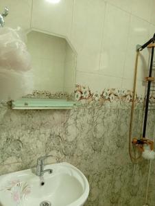 a bathroom with a sink and a mirror at Guest house TASO in K'veda Gordi