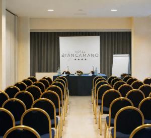 a meeting room with a table and chairs at Hotel Biancamano in Rimini +92 photos