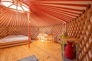 a room with a bed and a table in a yurt at Jurta na Jitrech in Tábor