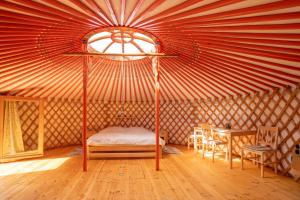 a room with a tent with a bed and a table at Jurta na Jitrech in Tábor