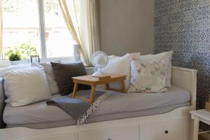 a room with a couch with pillows and a window at Cozy Smalandcottage Alsterfors 23 - towels, bed linen and toiletries provided - in Alsterfors