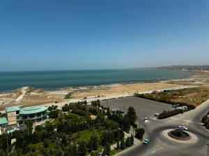 an aerial view of a parking lot next to the ocean at Caspian Boulevard Residence in Sumqayıt