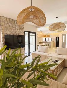 a living room with two white couches and a tv at Villa Sea House in Eilat