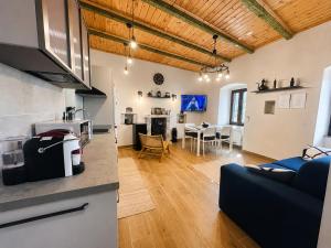 a kitchen and living room with a couch and a table at Ana & Angelo Stone House Vuno Himarë in Vuno