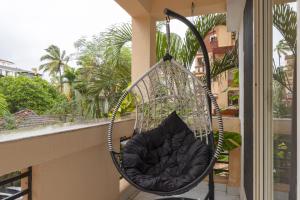 a hammock hanging on a balcony with a window at kumba stay in Kumbakonam