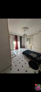 a room with a bed and a tiled floor at villa zgolli in Korba