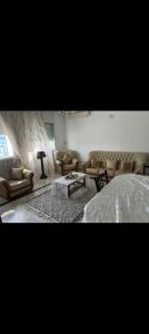a living room with couches and a bed at villa zgolli in Korba