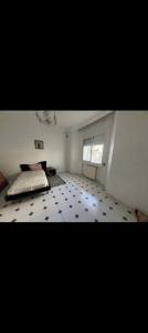 a room with a bed and a tiled floor at villa zgolli in Korba +2 photos