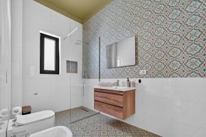 a bathroom with a toilet and a sink and a mirror at 2115 Boutique Hotel in Durrës