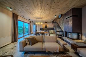 a living room with a couch and a fireplace at Vila Marigold in Opatija