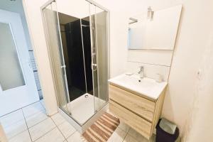 a bathroom with a sink and a shower at "Les Arches 2" City Center Studio in Saintes