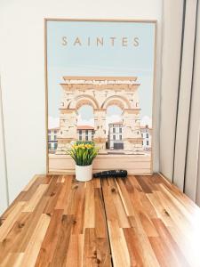 a picture of a picture of a building on a wall at "Les Arches 2" City Center Studio in Saintes