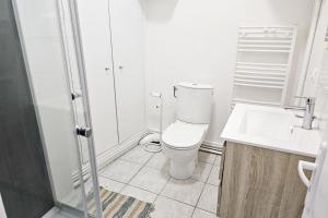 a white bathroom with a toilet and a sink at "Les Arches 2" City Center Studio in Saintes