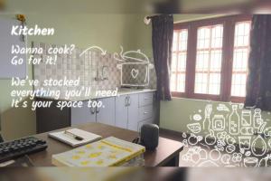 an office with a desk with a writing on the wall at Gokarna Homestay in Kathmandu