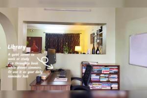 an office with a desk with a computer and a mirror at Gokarna Homestay in Kathmandu