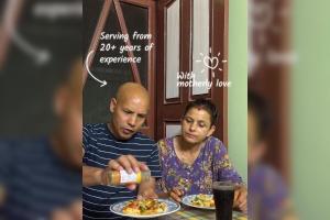 two people sitting at a table with plates of food at Gokarna Homestay in Kathmandu +1 photo