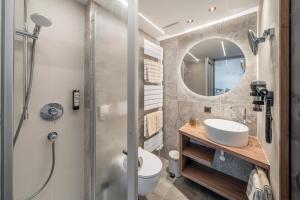 a bathroom with a shower and a sink and a mirror at Garni Ötztal ROOMS & APARTS in Sölden +86 photos