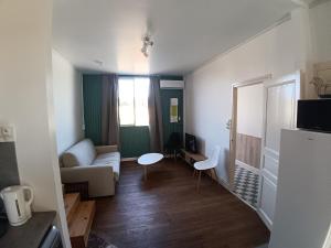 a living room with a couch and a table at le bégare 