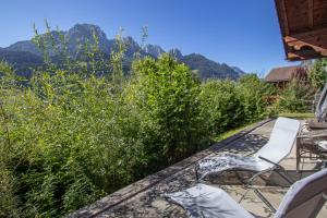 a patio with chairs and a view of the mountains at Les Jumelles in Rougemont