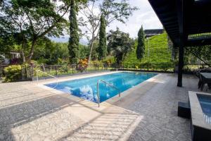 a swimming pool with a fence around it at Selva del Rio San Jeronimo in San Jerónimo
