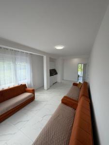 a living room with two couches and a couch at Apartments Gzim Peja in Ulcinj