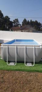 a swimming pool in a boat on the grass at Casa Alex in Arão