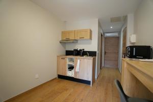 a small kitchen with a counter and a microwave at T2 Les Suites du Roubion in Montélimar