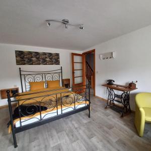 a bedroom with a bed and a couch and a table at A l'éc'Art in Wellin +53 photos