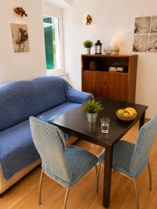 a living room with a blue couch and a table at Guest House Elizabeta in Split